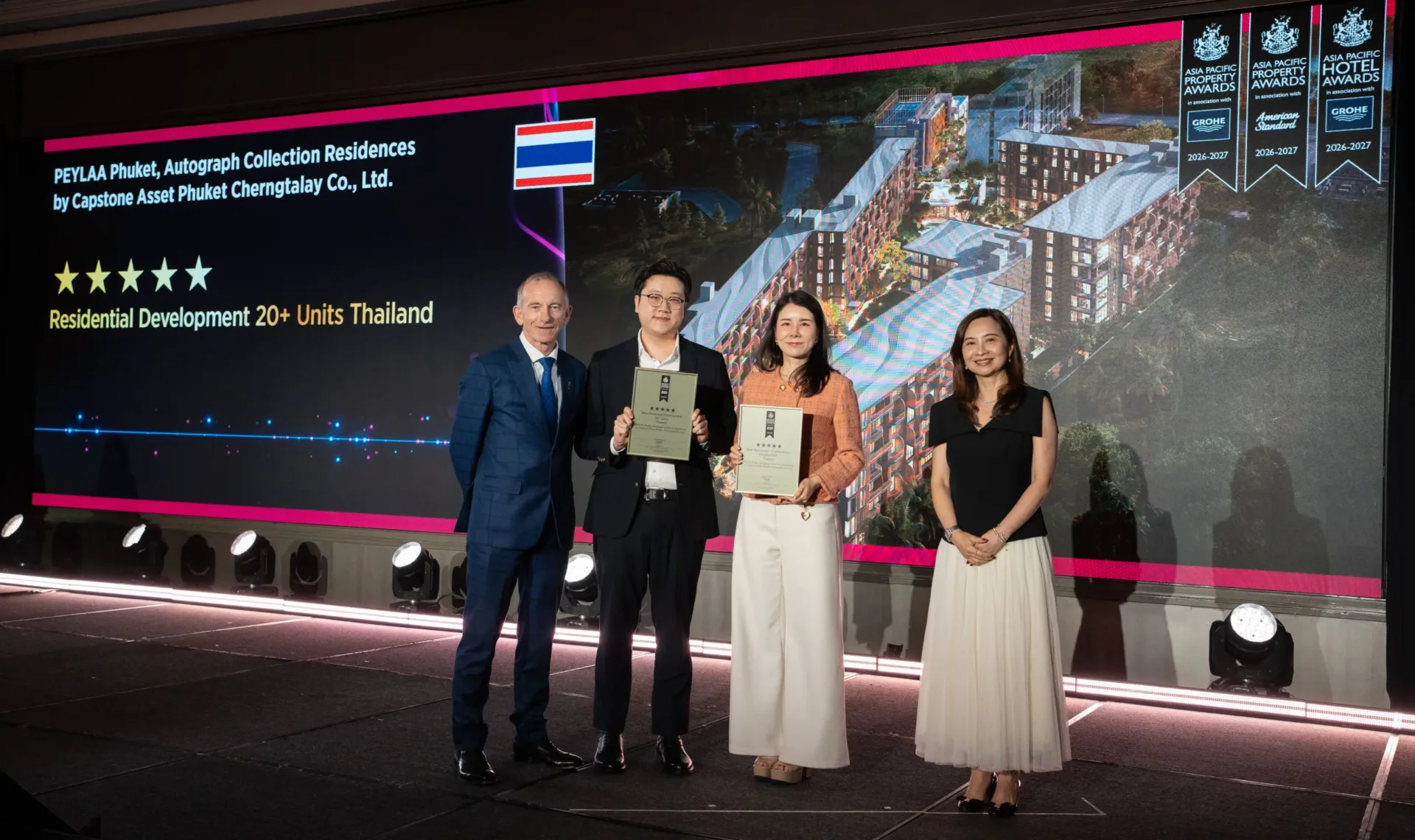 Capstone Asset executives holding two five-star Asia Pacific Property Awards 2026–2027 certificates for PEYLAA Phuket