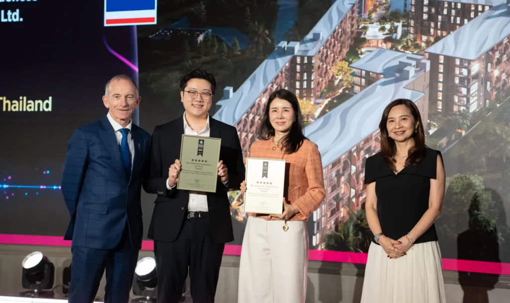 Capstone Asset executives holding two five-star Asia Pacific Property Awards 2026–2027 certificates for PEYLAA Phuket